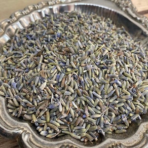 May include: A silver bowl filled with dried lavender buds. The lavender is a mix of purple and green.