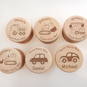 Op de afbeelding: Zes houten tandenfee-doosjes met verschillende voertuigontwerpen en gepersonaliseerde namen. De doosjes zijn gegraveerd met "Tooth Fairy Box" en de namen "Henry's", "Samuel's", "Ethan's", "Andrew's", "Daniel" en "Michael".