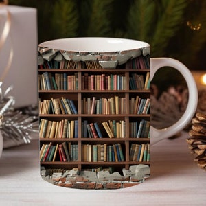 May include: White ceramic mug with a bookshelf design. The bookshelf is filled with books and is set against a brick wall with a broken section revealing the books.
