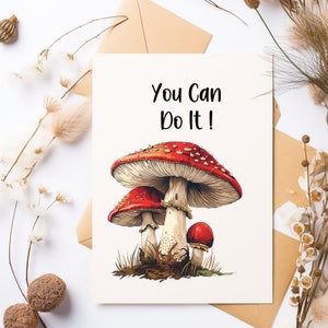 May include: A white card with the text "You Can Do It!" printed in black. The card features a colorful illustration of three red and white mushrooms.