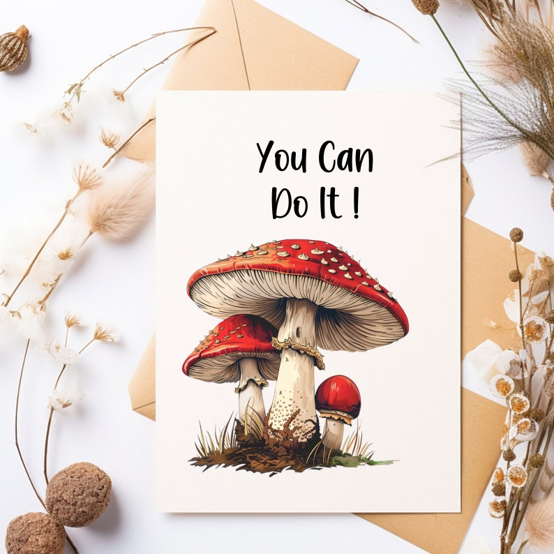 May include: A white card with the text "You Can Do It!" printed in black. The card features a colorful illustration of three red and white mushrooms.