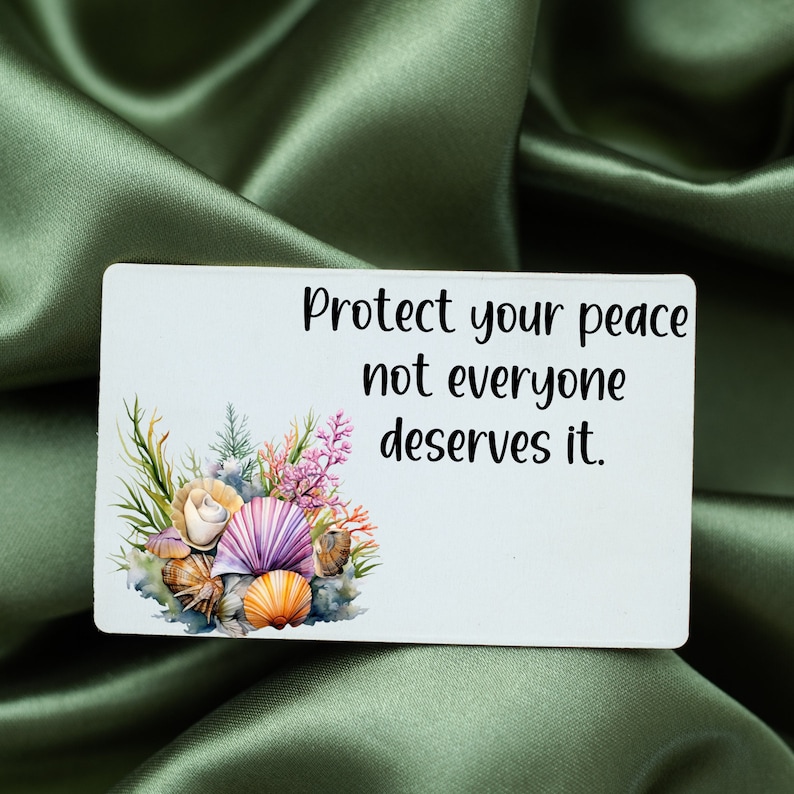 May include: White card with the text "Protect your peace not everyone deserves it."  The card has a watercolor illustration of seashells and coral.