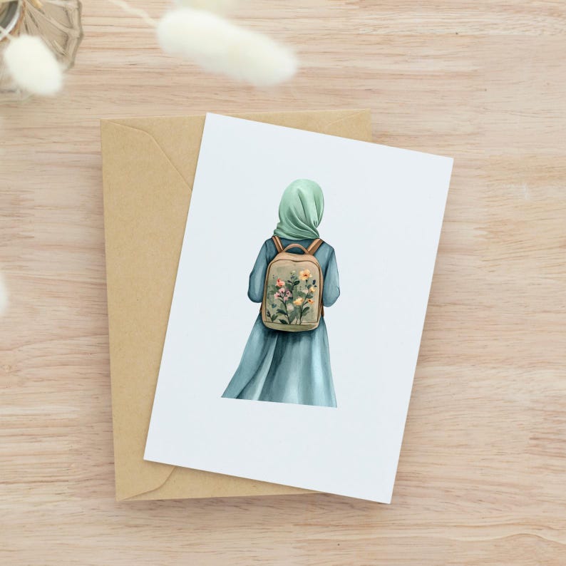 May include: A watercolor illustration of a person wearing a teal dress and a light green hijab, with a floral backpack. The image is on a white card, resting on a brown envelope, set against a wooden background.