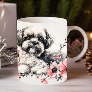 May include: White ceramic mug with a black and white watercolor illustration of a Shih Tzu dog surrounded by pink flowers.