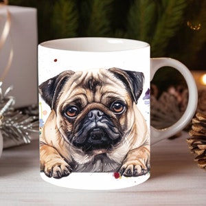 May include: White ceramic mug with a watercolor illustration of a pug dog peeking over the rim. The dog has brown fur, a black nose, and brown eyes. The background is white with watercolor splatters in shades of blue, purple, and brown.