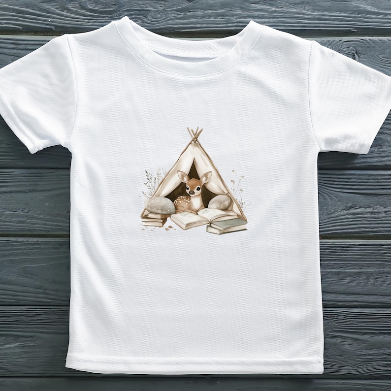 May include: White t-shirt with a brown deer reading a book inside a teepee. The teepee is surrounded by rocks and flowers.