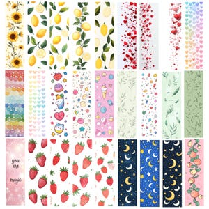 May include: A collection of decorative bookmarks with various designs. The designs include sunflowers, lemons, hearts, cute characters, strawberries, moons and stars, and peaches. One bookmark has the text "you are magic".