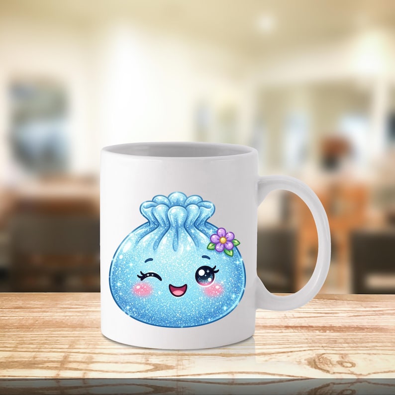 May include: A white ceramic mug featuring a graphic of a round, light blue, glittery dumpling character. The character has a winking eye, a smiling mouth, pink cheeks, and a small purple flower on its side, all rendered in a cute style.