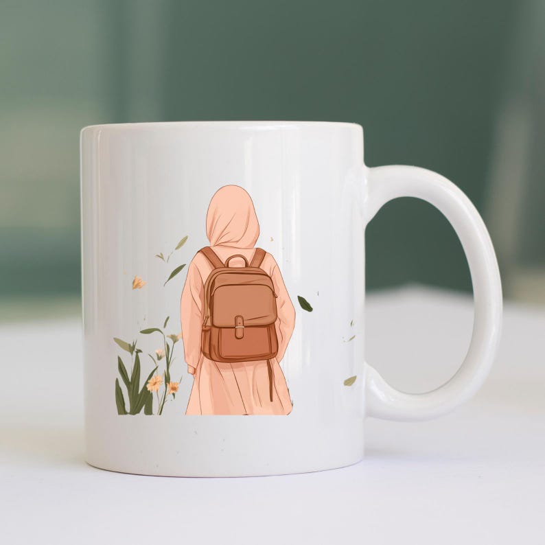 May include: White ceramic mug featuring an illustration of a person wearing a hijab and a backpack, standing in a field with flowers and plants. The person is facing away from the viewer. The mug has a curved handle.