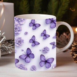 May include: A white ceramic mug with a purple butterfly and flower pattern. The mug has a handle on the right side.
