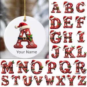 May include: A white ceramic Christmas ornament with a gold string, featuring a red letter "A" in a Santa hat design. The ornament has the text "Your Name" below the letter. Additional letters A-Z are also shown.