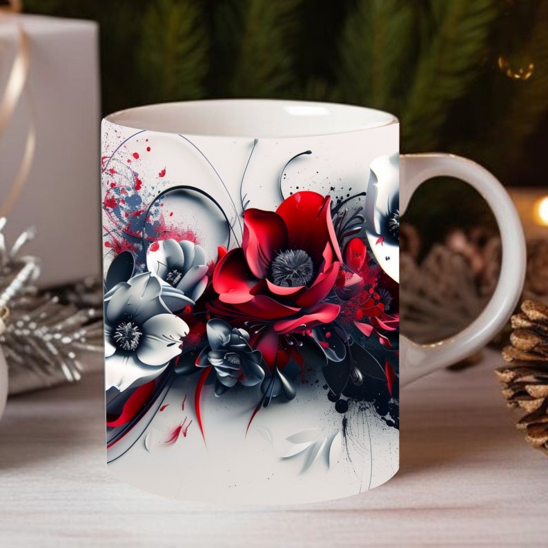 Peut inclure: Une tasse en c&eacute;ramique blanche avec un motif floral rouge, blanc et noir. Les fleurs sont stylis&eacute;es et ont un aspect pictural.