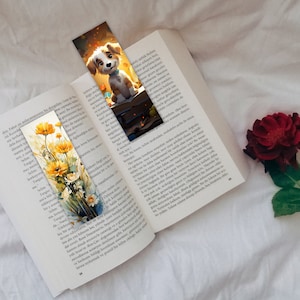 May include: A bookmark featuring a cartoon dog with brown fur, a white chest, and brown eyes. The dog is sitting on a stack of books with a yellow and orange glow behind it. The bookmark is placed on a book with text in a foreign language.