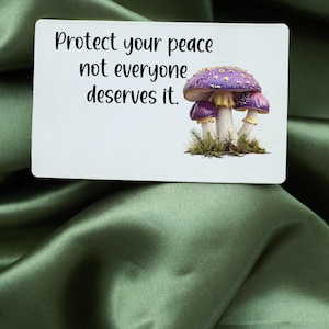 May include: White card with the text "Protect your peace not everyone deserves it." and a purple and gold mushroom illustration.