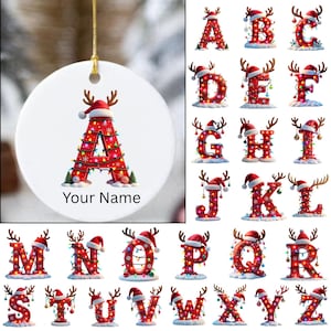 May include: A white ceramic Christmas ornament with a gold string, featuring a red letter "A" decorated with Christmas lights, a Santa hat, and reindeer antlers. The text "Your Name" is below the letter. A selection of other letters are also shown.
