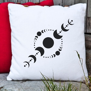 May include: White throw pillow with a black design of a circle with a large black circle in the center and a series of smaller black circles around the edge. The design is reminiscent of a moon cycle.