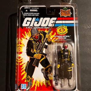 May include: A G.I. Joe Python Patrol Officer action figure in its original packaging. The packaging features a red and yellow background with the G.I. Joe logo and the words "A Real American Hero." The figure is wearing a black uniform with yellow accents.
