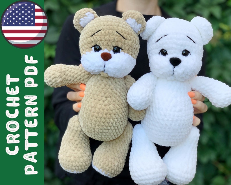 May include: Two crocheted teddy bears, one brown and one white, with black eyes and a black nose. The bears are sitting on a person's lap.