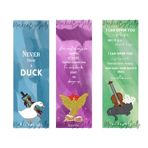 May include: Three colorful bookmarks with watercolor backgrounds and inspirational quotes. The first bookmark is blue with a white duck and the quote "Never trust a duck". The second bookmark is purple with a golden angel and a book and the quote "One must always be careful of books and what is inside them. For words have the power to change us". The third bookmark is green with a black cat and a violin and the quote "I can offer you my life but it is a short life. I can offer you my heart though I have no idea how many more beats it shall sustain."
