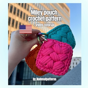 May include: Three square crochet pouches in bright pink, teal, and orange, each featuring a woven texture and attached to a rainbow-colored metal ring. Text reads: Miley pouch crochet pattern + video tutorial by Nadenafpatterns with a US flag icon.