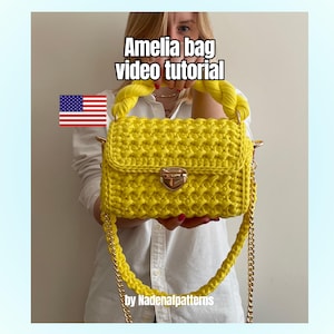 May include: A bright yellow crocheted handbag featuring a braided top handle, a gold-tone metal clasp closure, and a matching yellow crocheted shoulder strap with gold-tone metal chain links. The text Amelia bag video tutorial is visible.