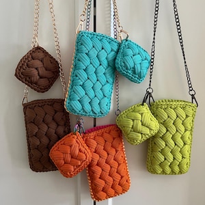 May include: A collection of rectangular crochet pouches and matching square coin purses in brown, turquoise, orange, and lime green. Each item features a woven cord texture and is attached to a metallic chain strap with a lobster clasp.