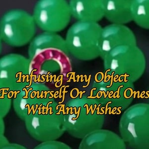 May include: A close-up of a necklace made of large, round, green beads. A small, circular, pink and gold charm is centered in the image. Text in gold reads: "Infusing Any Object For Yourself Or Loved Ones With Any Wishes."