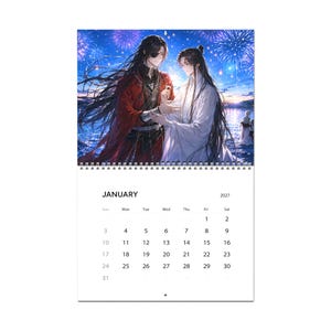 May include: A wall calendar for January 2027 featuring an illustration of two figures with long dark hair, one in red and black robes and one in white robes, standing before a night sky filled with blue fireworks over a body of water.