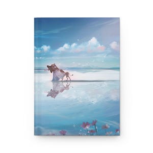 Puede incluir: Un diario de tapa dura con una serena ilustración de una criatura mítica y una figura caminando en el agua bajo un cielo azul con nubes. La portada tiene una estética suave y soñadora con colores pastel y una superficie de agua reflectante.