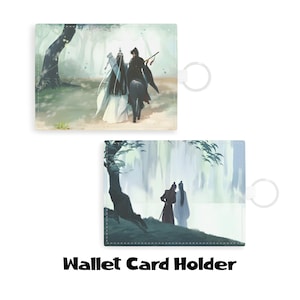 May include: Wallet card holder featuring a serene forest scene with two figures, one on horseback. The design includes a key ring attachment. The text "Wallet Card Holder" is printed at the bottom.