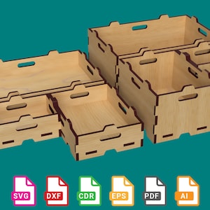 Peut inclure: Un ensemble de cinq boîtes de rangement en bois avec des finitions brunes. Les boîtes sont empilées et disposées en quinconce. Les boîtes sont conçues pour être découpées à l'aide d'une découpeuse laser.