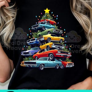 May include: A black t-shirt with a Christmas tree made of colorful muscle cars. The tree is decorated with a yellow star and colorful lights. The text "PNG & SUBLIMATION" is at the bottom of the image.