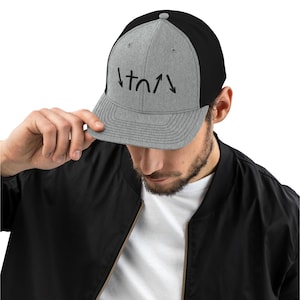 May include: A gray and black baseball cap with a black embroidered design of arrows and a horseshoe on the front.