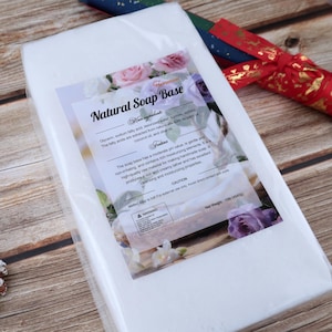 May include: A white rectangular package of "Natural Soap Base" with a floral label. The label includes text about ingredients and properties, and a warning. The net weight is 10lb (4540g).