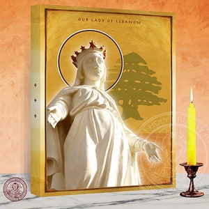 May include: A religious icon depicting Our Lady of Lebanon, a white statue of the Virgin Mary with a crown, standing in front of a gold background with a green cedar tree. The text "Our Lady of Lebanon" is written at the top of the image.