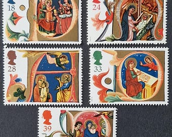 May include: A collection of five postage stamps featuring religious illustrations. Each stamp has a different image within a decorative border, depicting scenes with figures in robes, with gold and colorful accents. The stamps have values of 18, 24, 28, 33, and 39.