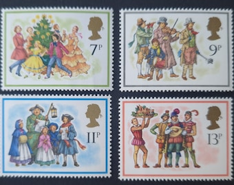 May include: Four vintage Christmas stamps from Great Britain featuring illustrations of people celebrating Christmas. The stamps are from 1973 and feature the denominations 7p, 9p, 11p, and 13p.