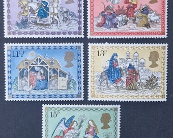 May include: Set of five vintage Christmas stamps from Great Britain. The stamps feature illustrations of the Nativity story, including the Three Wise Men, the shepherds, the angel Gabriel, and the birth of Jesus. The stamps are in denominations of 8p, 10p, 11 1/2p, 13p, and 15p.