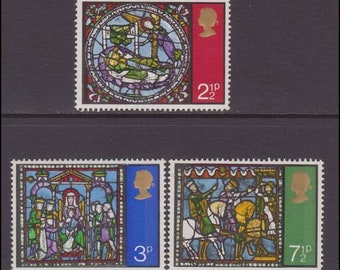 May include: A set of four vintage British postage stamps featuring stained glass artwork. The stamps depict scenes from the Bible, including the Nativity and the Three Wise Men. The stamps are in mint condition and have a face value of 21p, 3p, and 7 1/2p.