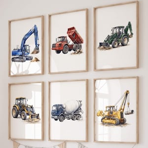 May include: A set of six framed watercolour prints featuring construction vehicles including a blue excavator, a red dump truck, a green backhoe, a yellow tractor, a blue cement mixer, and a yellow crane, all displayed in a grid on a white wall.