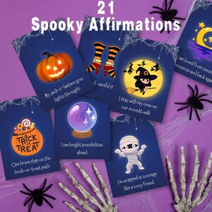 May include: A collection of 21 "Spooky Affirmations" cards with Halloween-themed illustrations. The cards feature images of a jack-o'-lantern, witch, mummy, and other spooky elements. The cards are on a purple surface with spider decorations.