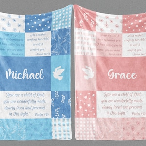 May include: Two personalized baby blankets with a patchwork design. One blanket is blue with white stars and the name "Michael" and the other is pink with white stars and the name "Grace". Both blankets feature a dove and a Bible verse.