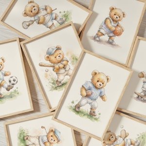 May include: A collection of framed watercolor prints featuring light brown teddy bears engaged in various sports, including lacrosse, basketball, baseball, football, soccer, and golf, each depicted in athletic uniforms on a light background.