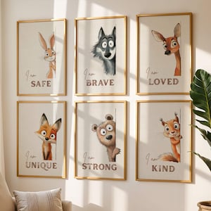 May include: Six framed art prints featuring cartoon animals: a rabbit, wolf, deer, fox, bear, and squirrel. Each print has a gold frame and a neutral background with the words "I am SAFE", "I am BRAVE", "I am LOVED", "I am UNIQUE", "I am STRONG", and "I am KIND".