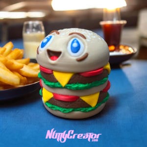 May include: A smiling, cartoon-style hamburger with a sesame seed bun, lettuce, tomato, cheese, and a beef patty. The hamburger is made of a light brown, beige, and green material. The hamburger is on a blue surface.