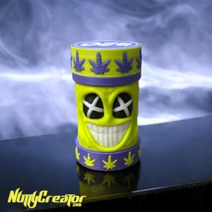 May include: A yellow and purple container with a smiling face and a marijuana leaf design. The container has a lid with the word "OG" on it.