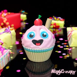 May include: A pink cupcake with a cherry on top and a straw sticking out. The cupcake has a happy face and big blue eyes. It is surrounded by colorful confetti and wrapped gifts.