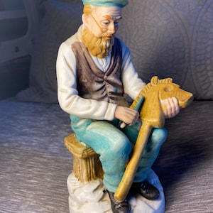 Vintage - Circa 1960&#39;s - Ceramic Figurine - Man Carving Hobby Horse - Wood Carver-  Teal Colored Trousers with Matching Newsboy Cap