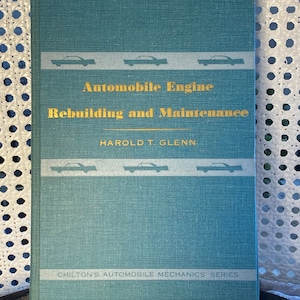 May include: A teal blue book titled "Automobile Engine Rebuilding and Maintenance" by Harold T. Glenn. The book is part of Chilton's Automobile Mechanics' Series.
