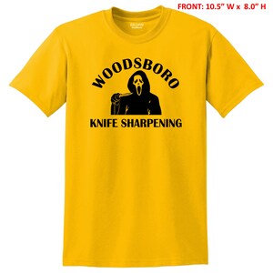 May include: Yellow t-shirt with a black graphic of a ghost holding a knife and the text "Woodsboro Knife Sharpening"